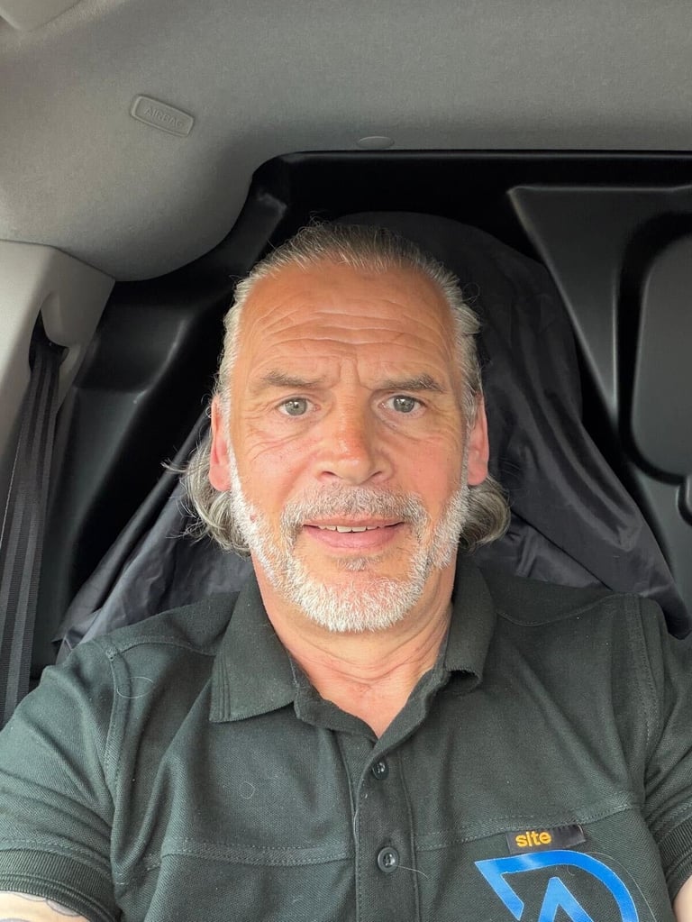 Keith, owner of A+ Services, sitting in his work vehicle